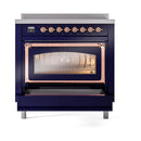 Midnight blue induction range, oven door open with visible interior rack and copper frame