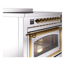 Stainless induction range with brass control knobs and open oven door