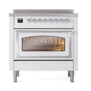 White induction range with lit triple-glass oven window and chrome control knobs