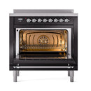 Glossy black induction range with illuminated oven cavity and chrome control knobs