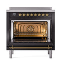 36-inch induction range with open oven door, black interior and brass accents, front