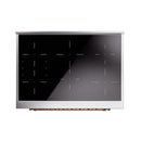 Glossy black induction range door with clear control window and copper accents