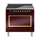 Burgundy induction range with closed oven door, brass handle trim, and control dials
