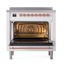 ILVE induction range with open oven door and copper-trim control knobs