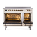 Antique white induction range with bronze-trimmed triple glass oven doors, open broiler view