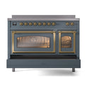 Blue grey induction range with oven doors open, brass handles and warm interior light