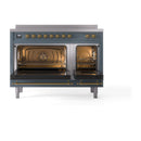 Blue grey induction range with open triple glass oven doors and brass handles, front view