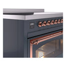Blue gray induction range control panel with copper knobs and oven window handle
