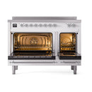 White induction range with both ovens open, chrome racks and warm interior glow