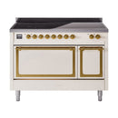 Antique white induction range with brass-trim ovens, cooktop, and black glass top