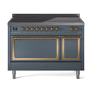Blue grey induction range with brass-trimmed knobs and dual oven doors closed