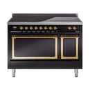 Glossy black induction range front with open brass-framed oven doors and controls