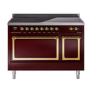 Burgundy induction range with double brass-trim ovens, gold knobs, and griddle top