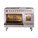 Stainless steel dual fuel range with copper trim; left oven open and illuminated