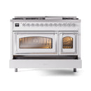 White dual-fuel gas range with lit main oven window and side oven door