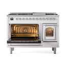White dual-fuel gas range with open main oven and illuminated interior