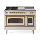 Antique white dual-fuel range with griddle top, brass knobs, and open oven doors