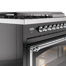Glossy black dual fuel range control panel with chrome knobs and oven handle trim