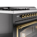 Glossy black range with brass control knobs and digital display panel