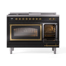Black range with one oven door open, showing interior racks and brass frame detail.
