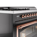 Front control panel and copper handle on glossy black dual-fuel range with oven door
