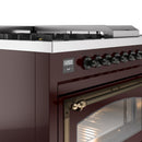 Burgundy control panel with clock display and round burner knobs above the oven door
