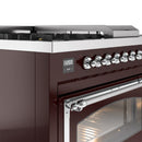 Burgundy dual fuel range control panel with knobs, oven door, and chrome trim