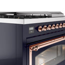 Freestanding gas range control panel detail with copper-trimmed oven door and knobs