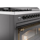 Matte graphite dual fuel range close-up of control panel and oven handle with bronze finish