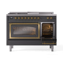 Dual fuel range with oven door open, brass trim, and interior racks