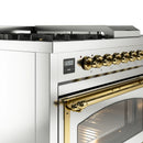 Dual fuel range control panel with gold brass knobs and digital display