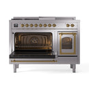 Dual fuel range with left oven door open, brass trim, and racks inside