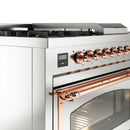 Stainless steel range control panel with copper-trim knobs and oven door handle detail