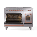 Stainless steel dual-fuel range with both ovens open, copper-trim trim, and visible burner grates
