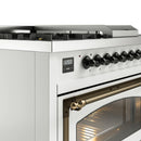 White dual-fuel range control panel with black knobs and bronze handle on open oven door