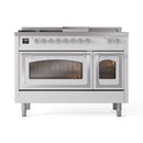 White dual fuel range with chrome control knobs, two oven doors, angled front view