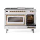 White dual-fuel range with brass trim, left oven door closed, right door open