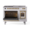 White dual-fuel range with brass trim, left oven door open and right glass door