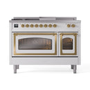 White dual-fuel range with brass trim and two glass oven doors