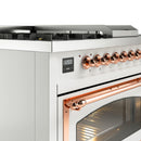White dual-fuel gas range control knobs with copper trim and oven door handle