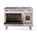 White dual-fuel gas range with both ovens open and copper-framed door trim