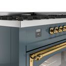 Blue-grey range control panel with brass knob cluster and brass oven handle