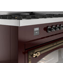 Burgundy gas dual-fuel range control panel with bronze knobs and clock display