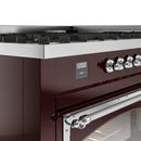Burgundy dual fuel gas range control panel with chrome knobs and digital display.
