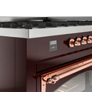 Burgundy dual fuel range control panel with digital display and copper knobs