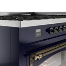 Midnight blue dual-fuel range control panel with clock display and bronze knobs