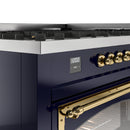 Midnight blue control panel with brass knobs, display, and oven handle trim
