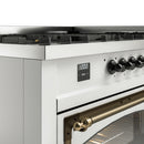 White dual fuel range control panel with dark knobs and digital clock display