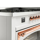 Close-up of white range control panel with copper knobs and digital display; cooktop behind.