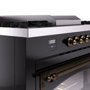 Black dual fuel gas range control panel with bronze burner knobs and digital display